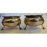 A pair of Georgian style silver circular, bulbous salt cellars with decoratively cast,