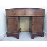 An early 19thC and later mahogany bow front sideboard with cast brass lion mask and ring handles,
