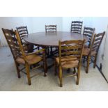 A modern Old English style oak wake design dining table, the oval top with deep fall flaps,