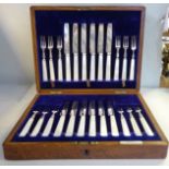 A set of twelve silver dessert knives and forks,