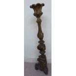 A late 18thC Continental gilded gesso (possibly limewood) candlestand with a triform knopped stem