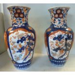 A pair of early 20thC Imari porcelain baluster shaped vases with wide necks and flared rims,