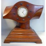 An early 20thC walnut cased mantel timepiece,