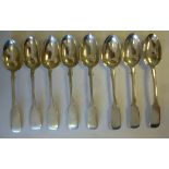 A matched set of eight Victorian silver fiddle pattern dessert spoons mixed marks