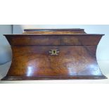 A Regency mahogany tea casket of waisted sarcophagus form with opposing flank ring handles and a