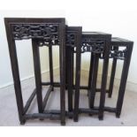 An early 20thC nesting set of four Chinese fruitwood occasional tables,