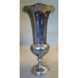 A silver trumpet vase with a flared, wavy rim, on a loaded,