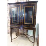 An 18thC inspired Continental black lacquered and gilded cocktail cabinet,