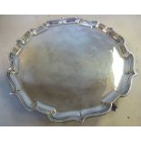 A Georgian style silver salver with a raised piecrust border,