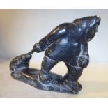 An Inuit carved black stone figure, hauling a captured seal 5.