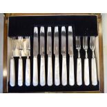 A set of six silver dessert knives and forks,