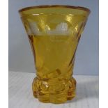 A late 19thC Bohemian amber coloured glass beaker vase with swirl moulded and dimple cut ornament,