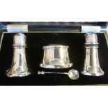 A three piece silver condiments set of tapered form comprising a mustard pot,
