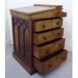 A mid Victorian burr walnut veneered Davenport, the angled, hinged lid,