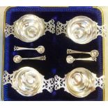 A set of four Edwardian silver salt cellars,