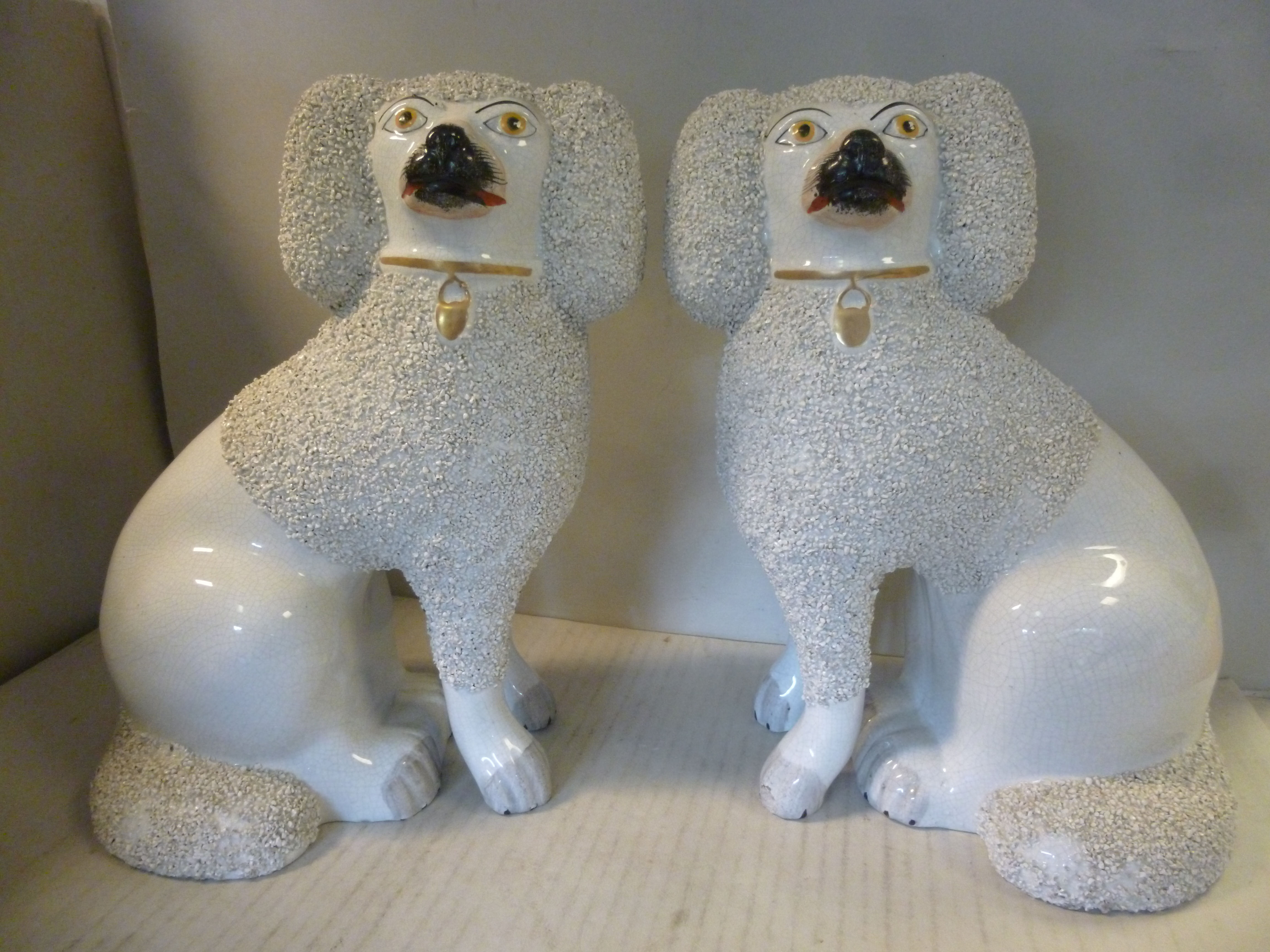 A pair of late 19thC Staffordshire ivory glazed and textured pottery models,