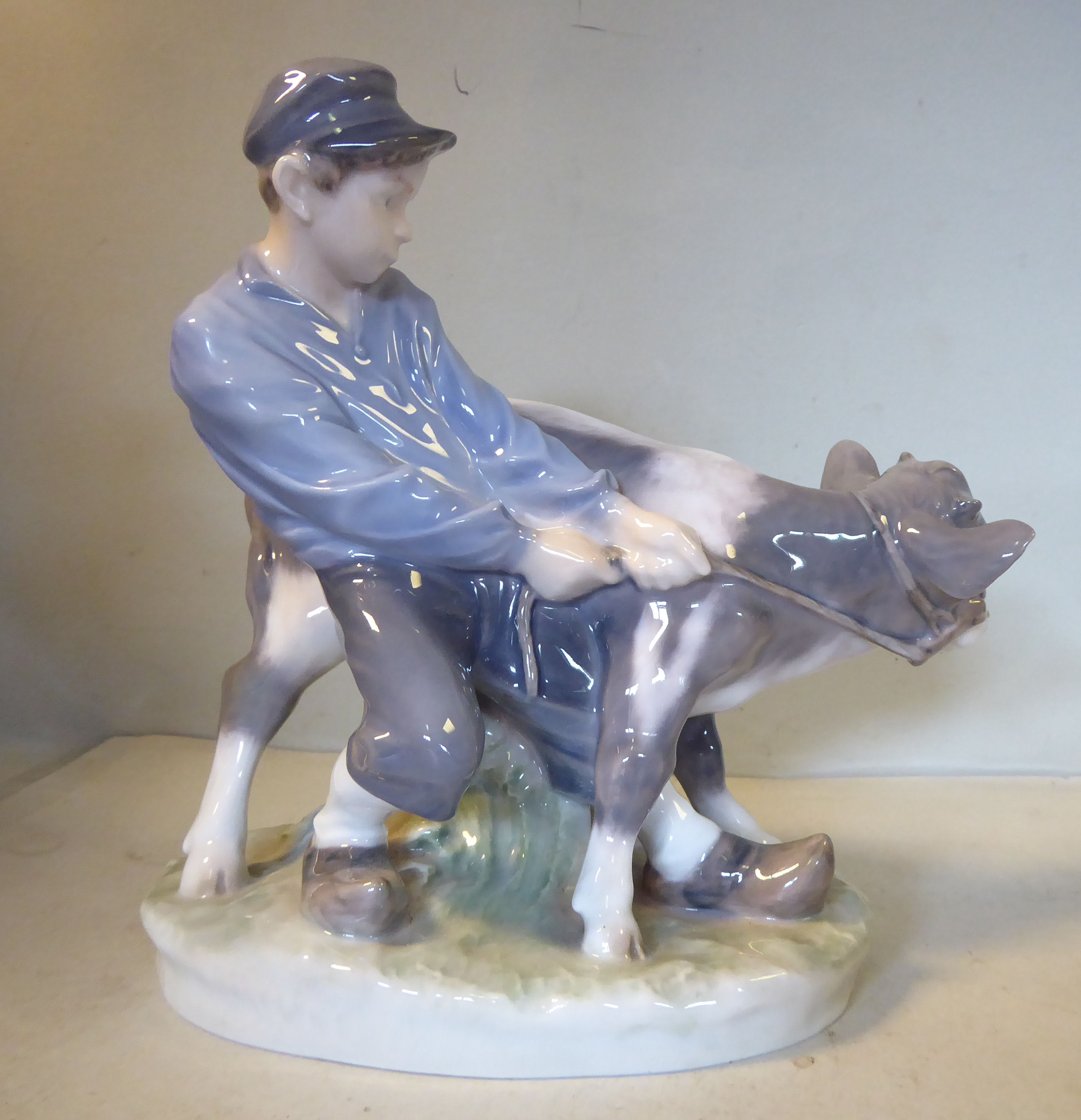 A Royal Copenhagen porcelain model 'Boy with Calf' by C Thomsen, no.