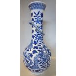 A late 19thC Chinese porcelain bottle vase, the long, slender neck surmounted by a moulded reptile,