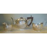 A bachelor's three piece silver tea set of oval, wrythen moulded,
