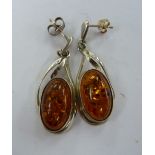 A pair of silver mounted amber coloured pendant earrings 11