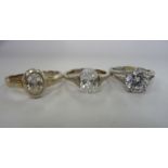 Three silver solitaire rings,