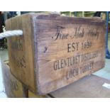 A retailer's softwood crate with opposing rope handles bears an advertisement for Glenturet,