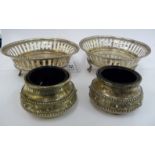 A pair of mid Victorian silver cauldron design salt cellars with blue glass liners,