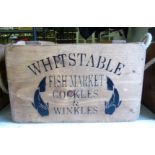 A retailer's softwood crate with opposing rope handles bears an advertisement for Whitstable Fish