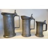 Three similar early 19thC French pewter measures of straight, cylindrical form with angular handles,