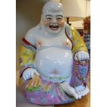 A 20thC porcelain figure, a seated Buddha,