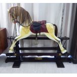 A Special Millenium Limited Edition 190/500 carved and painted wooden nursery rocking horse with a