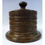 A mid 19thC multi-ring turned fruitwood spice box with straight sides,