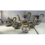 An Edwardian six piece silver tea and coffee set of oval, demi-reeded and fluted,