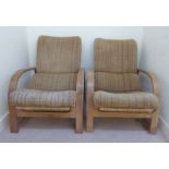 A pair of early 1930s Art Deco laminated light oak framed reclining armchairs,