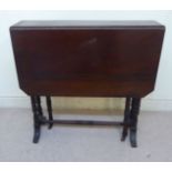 A late Victorian walnut Sutherland table, the top with canted corners, over turned pillar uprights,