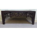 An early 20thC Chinese, dark stained elm, low table,