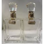 A pair of clear glass decanters of chamfered,