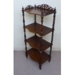 A late Victorian walnut four tier serpentine front what-not,