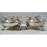 A pair of early Victorian silver ogee shaped salt cellars with shell and scroll cast rims,