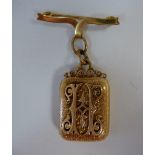 A Victorian yellow metal 'box' locket, the hinged cover enclosing two picture apertures,