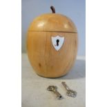 A 20thC turned and carved maplewood tea caddy in the form of an apple with a lockable,