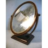 An Edwardian double sided toilet mirror, the larger,