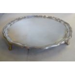 A Georgian style silver salver with a raised, ribbon tied and reed, piecrust border,