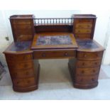 A late Victorian mahogany box top desk, the top having a central sloping, hinged scriber,