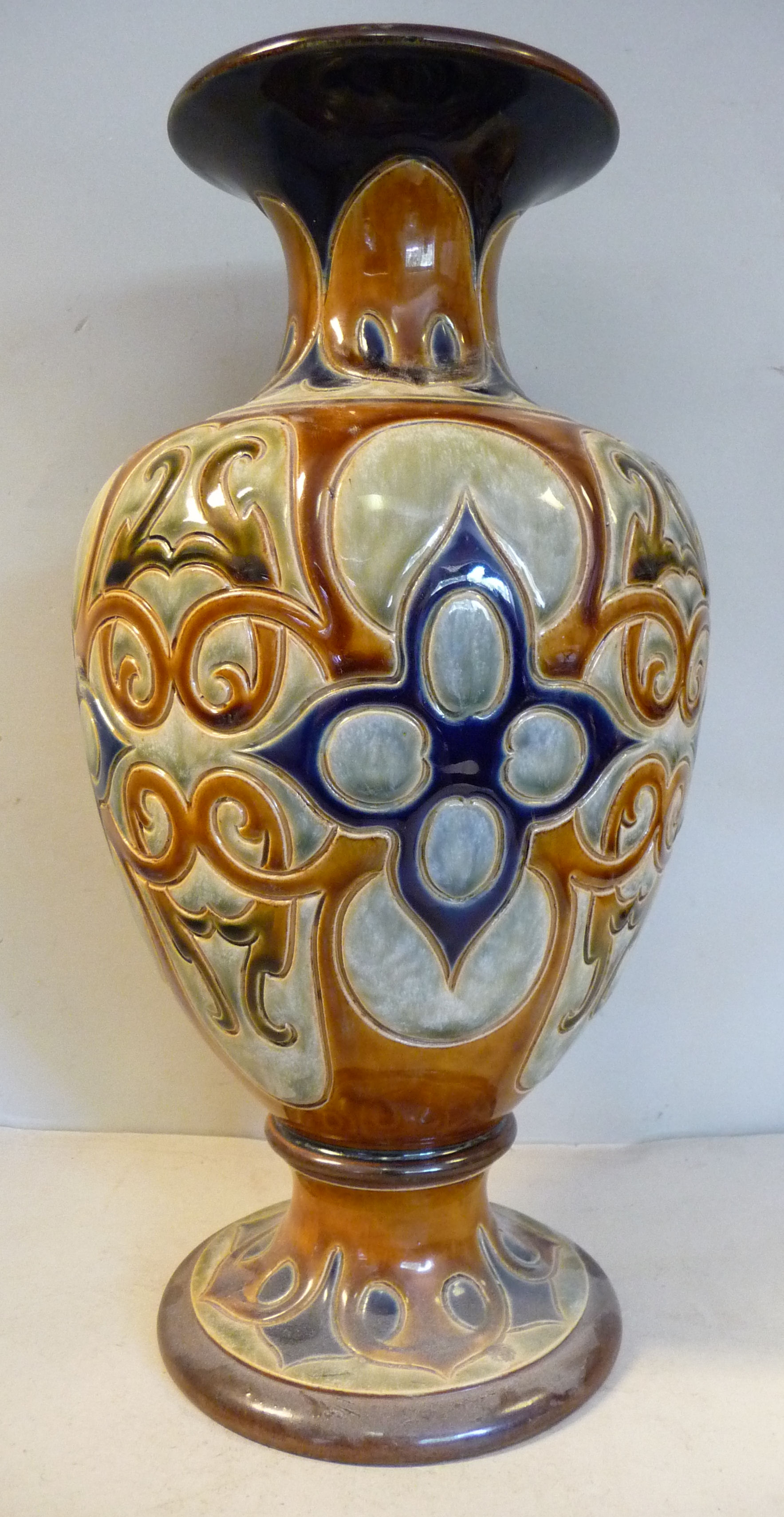 A Royal Doulton stoneware vase of shouldered, ovoid form with a narrow neck and flared rim,