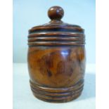 A late 19thC retailer's turned elm tobacco barrel with ring moulded ornament and a spherical knop
