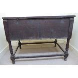 A late 18thC oak coffer with a plank constructed, hinged lid, over a panelled front and sides,