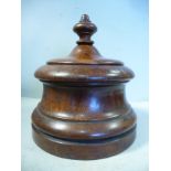 A mid 19thC retailer's turned walnut tobacco jar with a finial on the cover 7''h