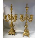 A pair of early 20thC Continental brass candelabra, cast in rococo taste,