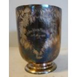 A mid Victorian silver Christening mug of tapered form with a bead-top, hollow C-scrolled handle,